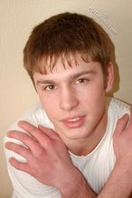 Leggy teen posing sexily with his back against the wall