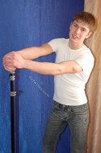Leggy teen posing sexily with his back against the wall