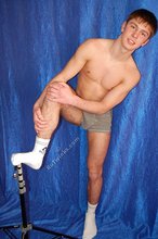 Muscular twink striking sexy poses in a studio