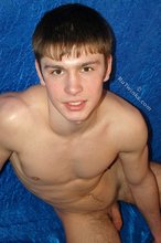 Dark-haired gay boy posing with his cock exposed