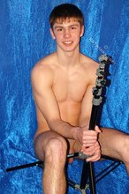 Dark-haired gay boy posing with his cock exposed