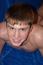 Dark-haired gay boy posing with his cock exposed