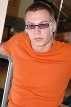 Cool shades twink posing shirtless in his gym