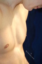 Muscular teen boy taking his jeans off on camera