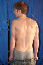 Muscular teen boy taking his jeans off on camera
