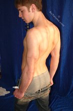 Muscular teen boy taking his jeans off on camera