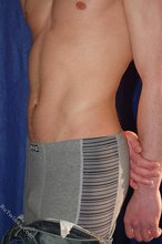 Muscular teen boy taking his jeans off on camera