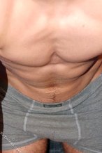 Muscular teen boy taking his jeans off on camera