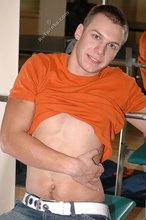 Orange t-shirt stud decides to pose seductively