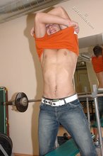 Orange t-shirt stud decides to pose seductively