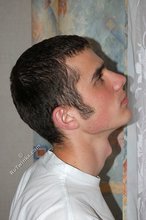 Soulful young boy posing shirtless on camera