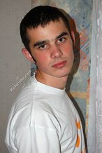 Soulful young boy posing shirtless on camera