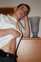 Soulful young boy posing shirtless on camera