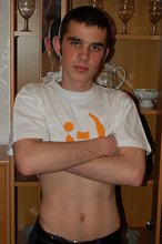 Soulful young boy posing shirtless on camera