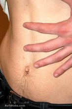 Soulful young boy posing shirtless on camera