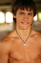 Incredibly tanned twink posing in a wrecked building