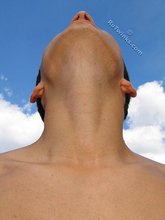 Muscular dark-haired guy strokes his cock outdoors