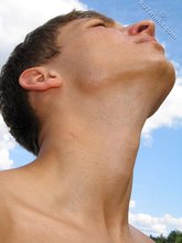 Muscular dark-haired guy strokes his cock outdoors