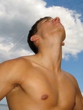 Muscular dark-haired guy strokes his cock outdoors