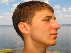 Muscular dark-haired guy strokes his cock outdoors