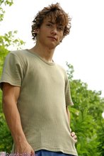 Curly-haired twink posing shamelessly outdoors