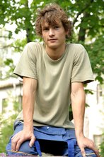 Curly-haired twink posing shamelessly outdoors