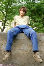 Curly-haired twink posing shamelessly outdoors