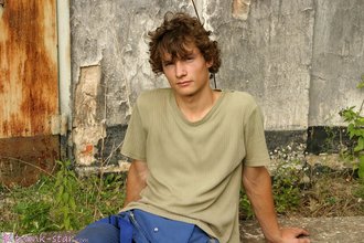 Curly-haired twink posing shamelessly outdoors