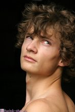 Curly-haired twink posing shamelessly outdoors
