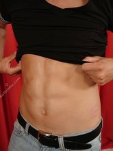 Pretty boy with sexy abs puts his clothes back on