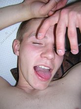 Gay twink making funny faces while eating cum