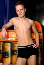 Round booty young twink posing on a recliner