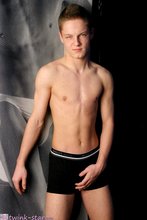 Round booty young twink posing on a recliner