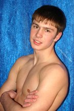 Dark-haired boy posing totally naked in a studio