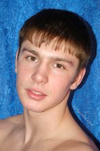 Dark-haired boy posing totally naked in a studio