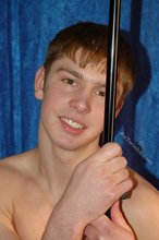 Dark-haired boy posing totally naked in a studio