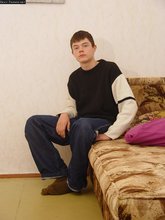 Horny young boy shows his feet and teases with his bulge