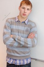 Blond-haired twink boy takes off his sexy sneakers and socks