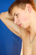 Blond-haired twink boy takes off his sexy sneakers and socks