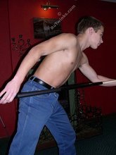 Young boy in loose-fitting jeans finally strips naked, almost