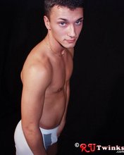 Tanned and muscular twink stripping in a very very dark room