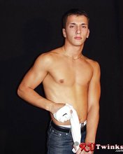 Young blue-eyed beauty showing his perfect body in a hot gallery