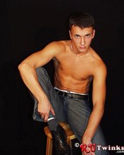 Young blue-eyed beauty showing his perfect body in a hot gallery