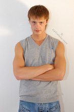 Blond-haired guy showing his armpits and muscular arms