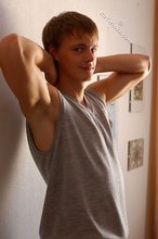 Blond-haired guy showing his armpits and muscular arms