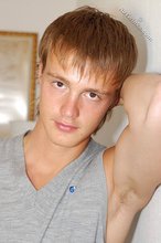 Blond-haired guy showing his armpits and muscular arms