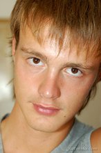 Blond-haired guy showing his armpits and muscular arms