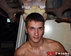 Dark-haired guy with a perfect body moving tires and looking hot