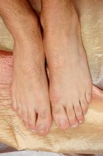Guy with a delightful body shows his hairy toes up close