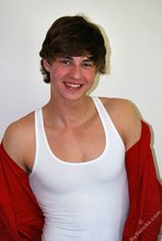 Guy with longish hair flashing his amazing abs on camera